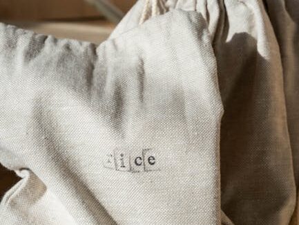 Eco-friendly cotton bags and glass jar emphasize zero waste lifestyle.